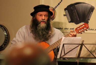 Photo of Alan.s.Robinson playing guitar at mansfield folk club